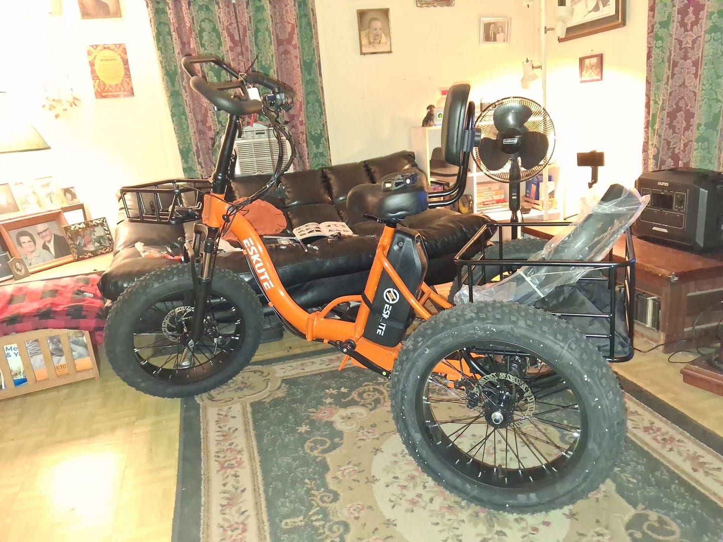 Customer's orange Eskute T302 Pro cargo e-bike assembled inside a living room.